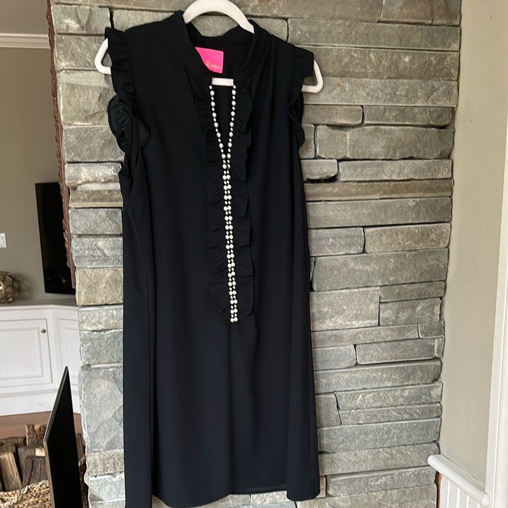 Black LP dress with flutter sleeves and zip front with Pearl Accents.